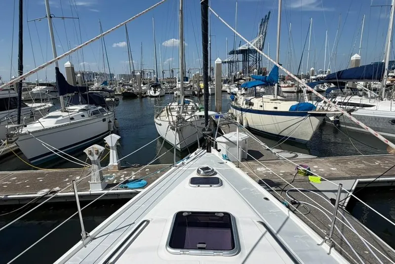 Slide: The Image of Sailboats docked at a marina, viewed from a 2002 Hunter 410 yacht. - 24
