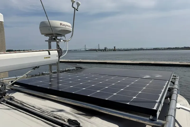 Slide: The Image of Solar panel on a 2002 Hunter 410 sailboat with radar, docked near a bridge. - 25