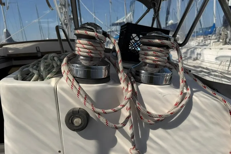 Slide: The Image of Winches and ropes on a 2002 Hunter 410 sailboat deck, with marina background. - 27