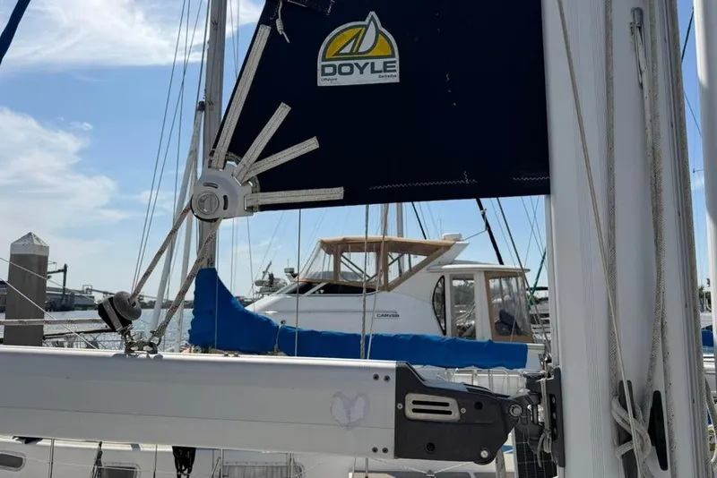 Slide: The Image of Sailboat mast and rigging of a 2002 Hunter 410, featuring Doyle sails at a marina. - 30