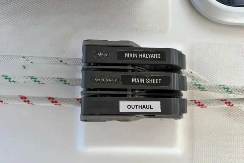 Slide: The Image of Close-up of labeled sailing rope clutches on a 2002 Hunter 410 yacht. - 32
