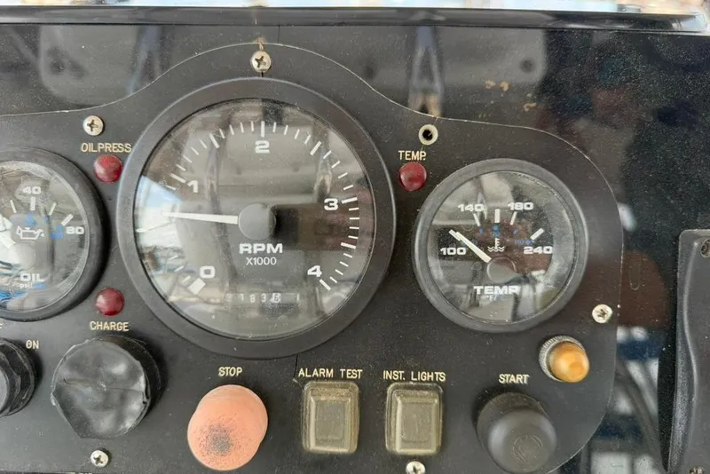 Slide: The Image of Control panel of a 2002 Hunter 410 boat with RPM and temperature gauges. - 38