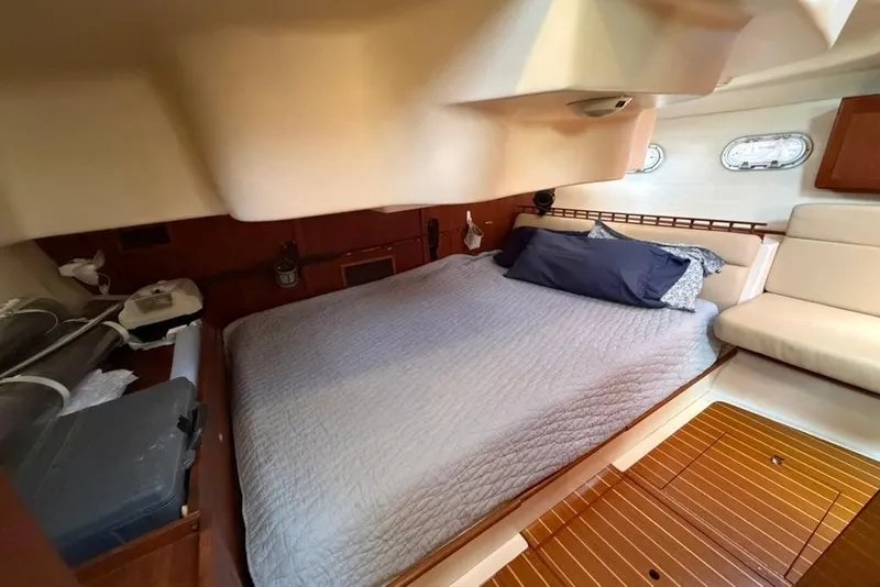 Slide: The Image of Cozy cabin interior of 2002 Hunter 410 sailboat with bed and wooden flooring. - 43