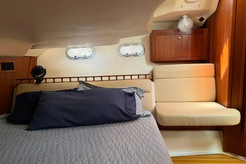 Slide: The Image of Cozy cabin interior of 2002 Hunter 410 sailboat with bed and seating area. - 44