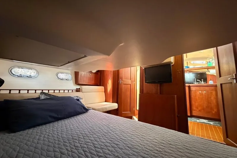 Slide: The Image of Interior of 2002 Hunter 410 yacht cabin with bed, seating, and kitchenette. - 45