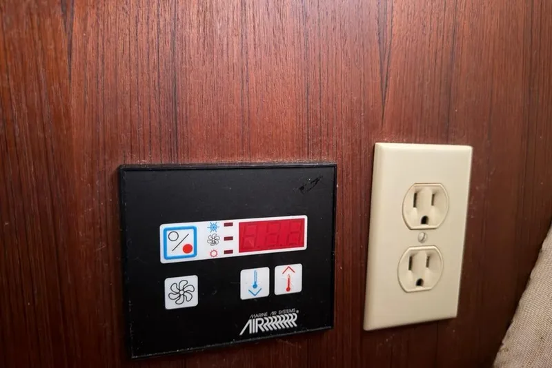 Slide: The Image of Control panel and electrical outlet on wooden wall, Hunter 410, 2002 model. - 48