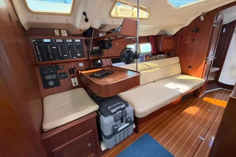 Slide: The Image of Interior of a 2002 Hunter 410 sailboat with wood paneling and navigation equipment. - 55