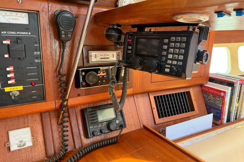 Slide: The Image of Control panel and radio equipment inside a 2002 Hunter 410 sailboat cabin. - 56