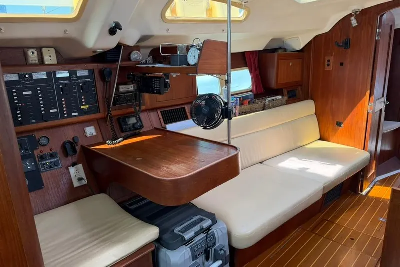 Slide: The Image of Interior of a 2002 Hunter 410 sailboat with navigation equipment and seating area. - 57
