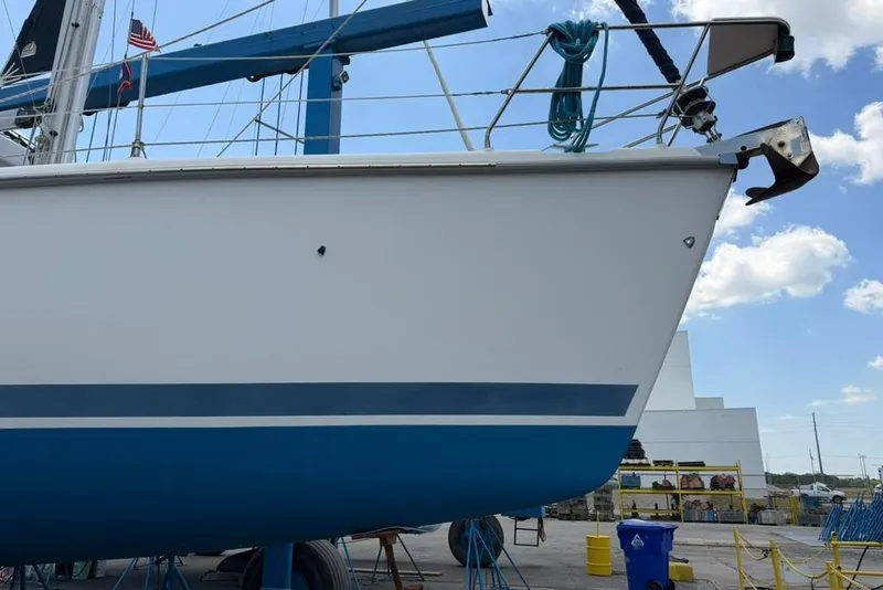 Slide: The Image of Sailboat Hunter 410 from 2002 on dry dock, blue and white hull visible. - 6