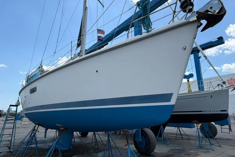 Slide: The Image of 2002 Hunter 410 sailboat on stands, ready for maintenance at a marina. - 7