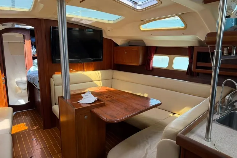 Slide: The Image of Luxurious interior of a 2002 Hunter 410 sailboat with wood finishes and cozy seating. - 74