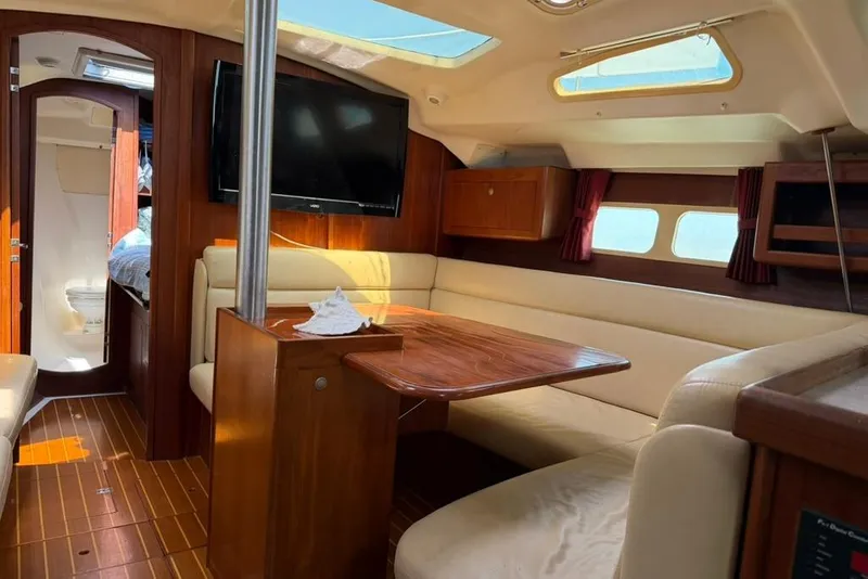 Slide: The Image of Interior of a 2002 Hunter 410 sailboat with cozy seating and wooden finishes. - 75