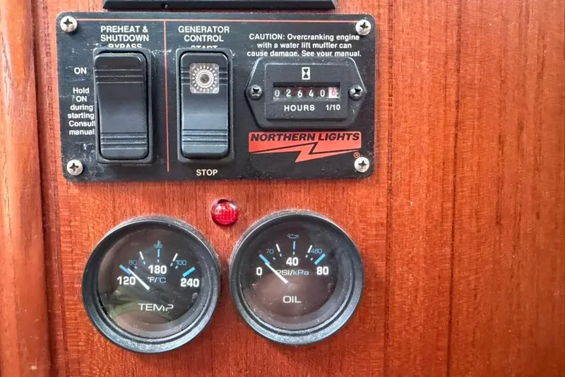 Slide: The Image of Control panel of a 2002 Hunter 410 boat with gauges and switches. - 90