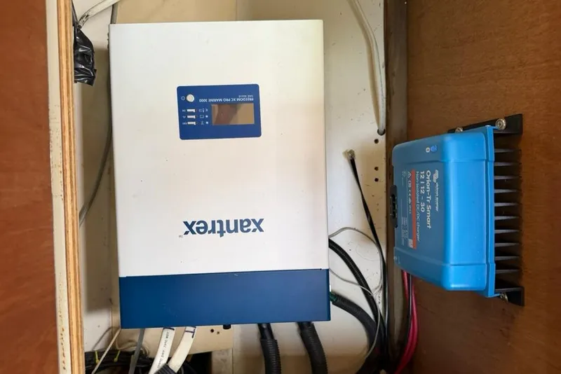 Slide: The Image of Inverter and charge controller setup in a 2002 Hunter 410 boat. - 93