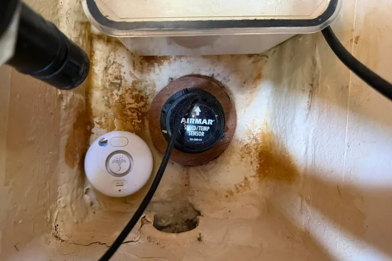 Slide: The Image of Airmar speed/temp sensor in Hunter 410 boat, 2002 model, with visible wiring. - 94
