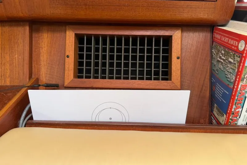 Slide: The Image of Wooden interior of a 2002 Hunter 410 yacht with vent and nautical charts. - 95