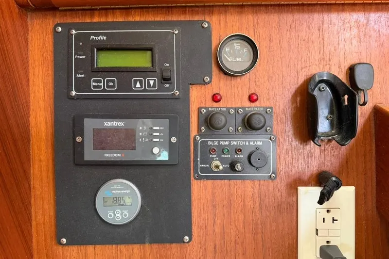 Slide: The Image of Control panel of a 2002 Hunter 410 sailboat with various gauges and switches. - 96