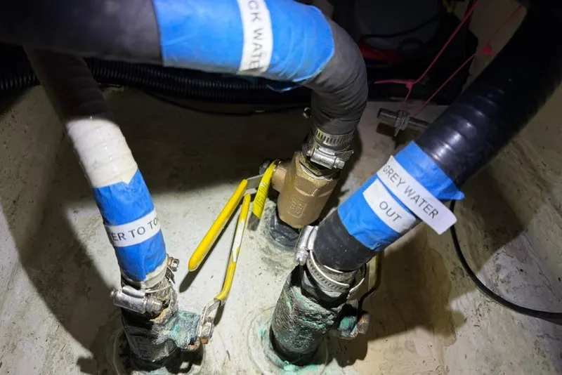Slide: The Image of Pipes and valves labeled for water management in a 2002 Hunter 410 boat. - 98