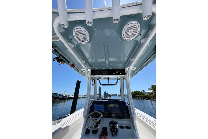 Slide: The Image of 2021 Sea Hunt Gamefish 27 Coffin Box boat interior with control panel and speakers. - 12