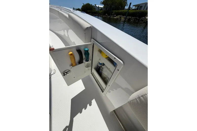 Slide: The Image of 2021 Sea Hunt Gamefish 27 Coffin Box with open storage compartment and tools. - 18
