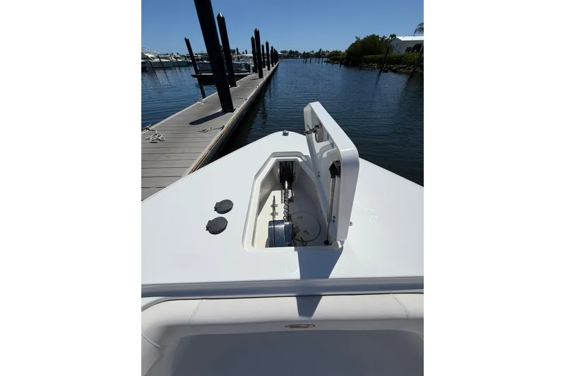 Slide: The Image of 2021 Sea Hunt Gamefish 27 Coffin Box boat docked at marina, showing anchor compartment. - 20