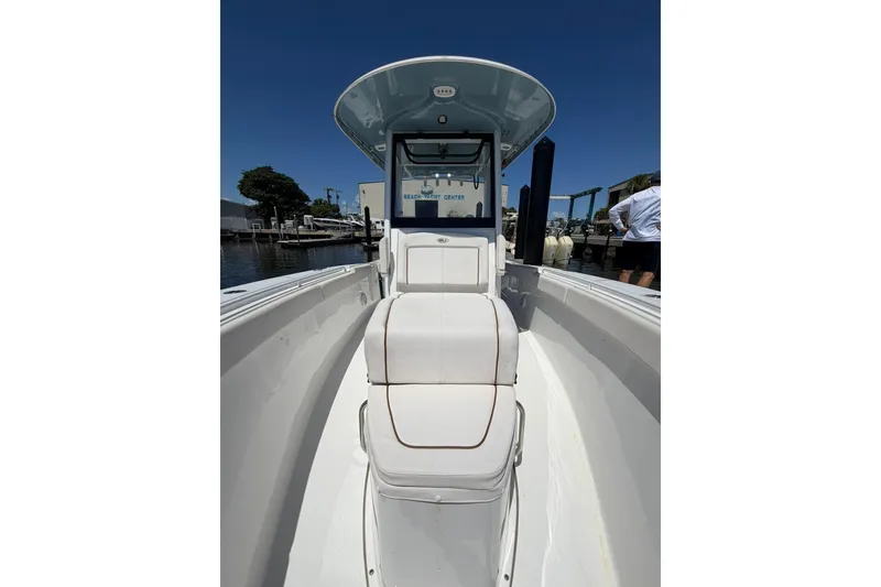 Slide: The Image of 2021 Sea Hunt Gamefish 27 Coffin Box boat, docked under clear blue sky. - 21