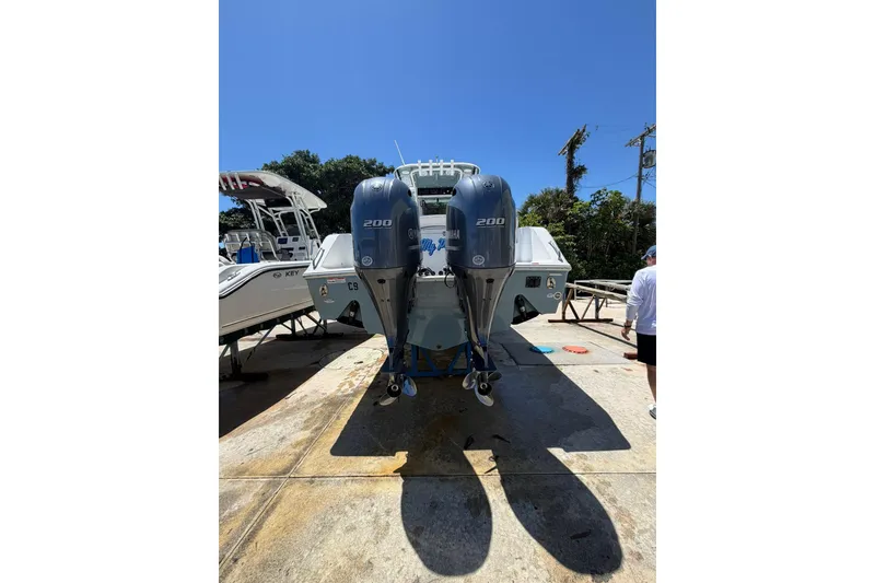 Slide: The Image of 2021 Sea Hunt Gamefish 27 Coffin Box with dual Yamaha 200 engines, docked outdoors. - 3