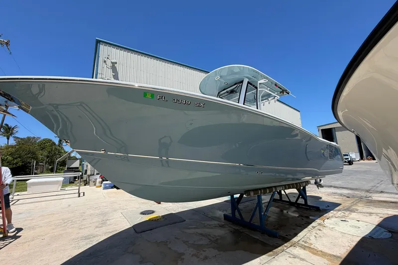 Slide: The Image of 2021 Sea Hunt Gamefish 27 Coffin Box boat on display under clear blue sky. - 4