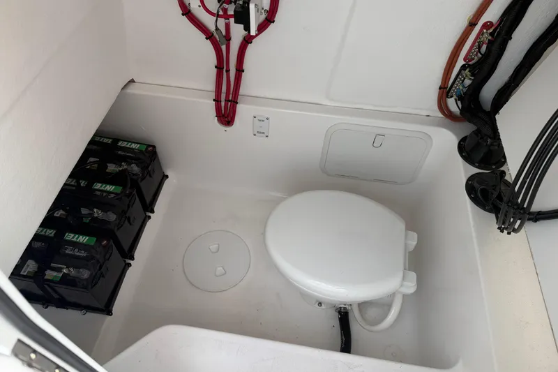 Slide: The Image of 2026 Clearwater 2800 Center Console boat interior with batteries and marine toilet. - 9