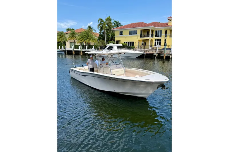 The Image of 2006 Grady-White Bimini 306 boat on water near waterfront homes. - 0