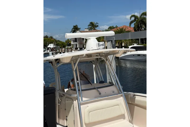 Slide: The Image of 2006 Grady-White Bimini 306 boat docked, featuring a sleek design and modern equipment. - 10