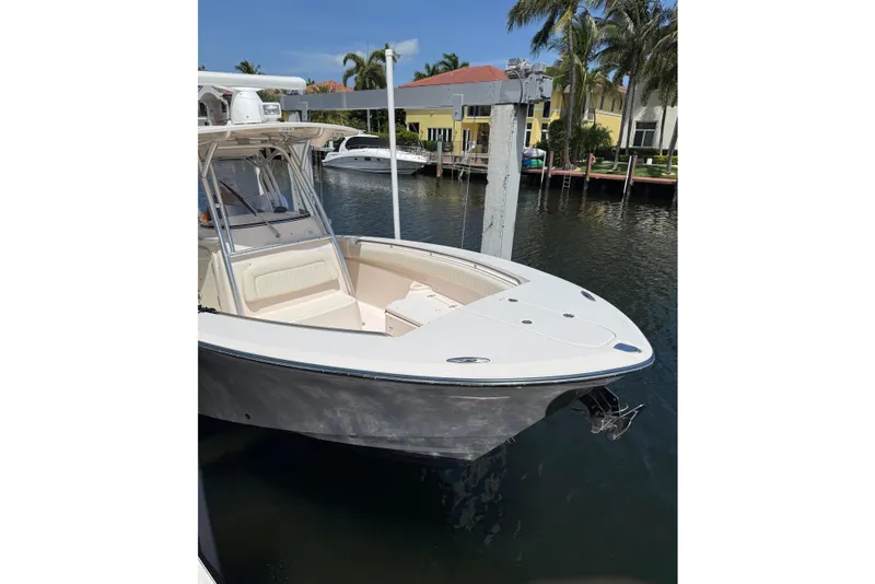 Slide: The Image of 2006 Grady-White Bimini 306 boat docked by waterfront homes. - 11
