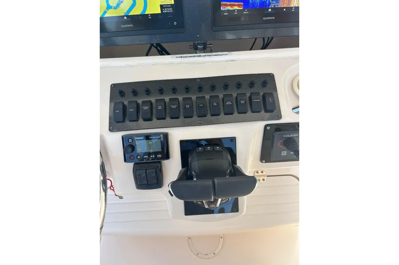 Slide: The Image of Control panel of a 2006 Grady-White Bimini 306 boat with Garmin displays. - 14