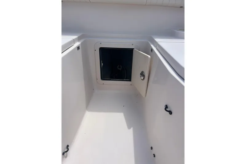 Slide: The Image of 2006 Grady-White Bimini 306 boat storage compartment with open hatch. - 17