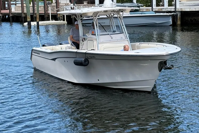 Slide: The Image of 2006 Grady-White Bimini 306 boat on water, featuring sleek design and spacious seating. - 2
