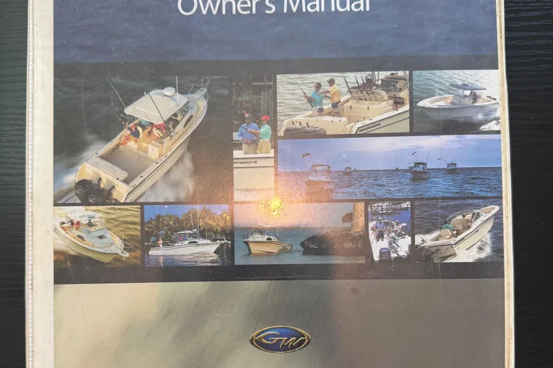 Slide: The Image of Owner's manual cover for 2006 Grady-White Bimini 306 boat, featuring various boating scenes. - 21