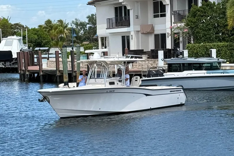 Slide: The Image of 2006 Grady-White Bimini 306 boat docked near waterfront homes. - 3