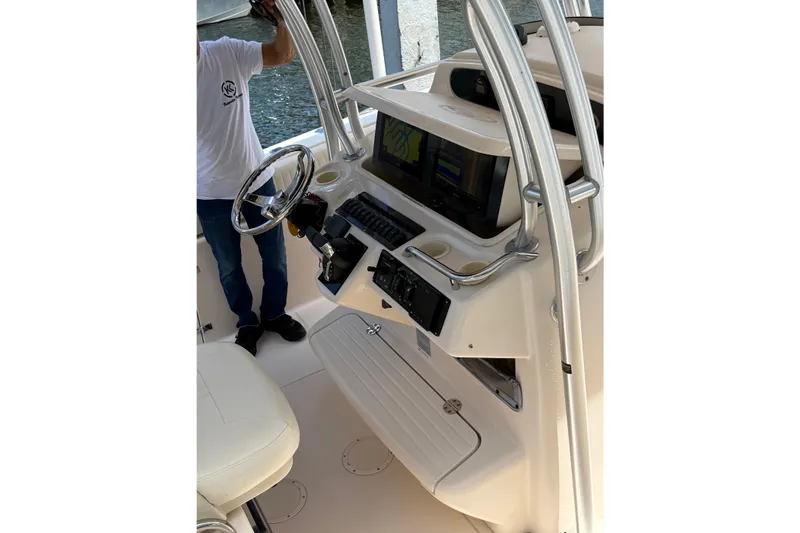 Slide: The Image of 2006 Grady-White Bimini 306 boat console with steering wheel and navigation equipment. - 5