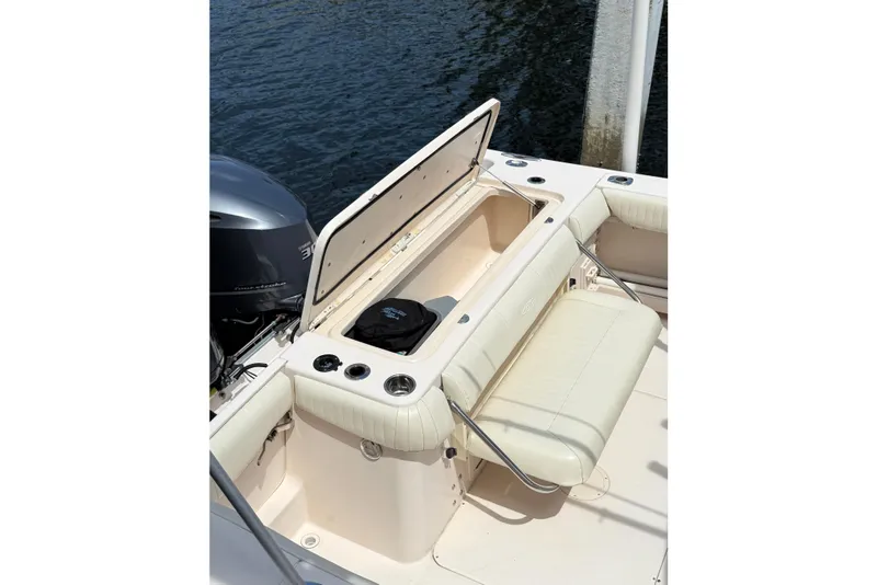 Slide: The Image of 2006 Grady-White Bimini 306 boat with open storage compartment and seating. - 8