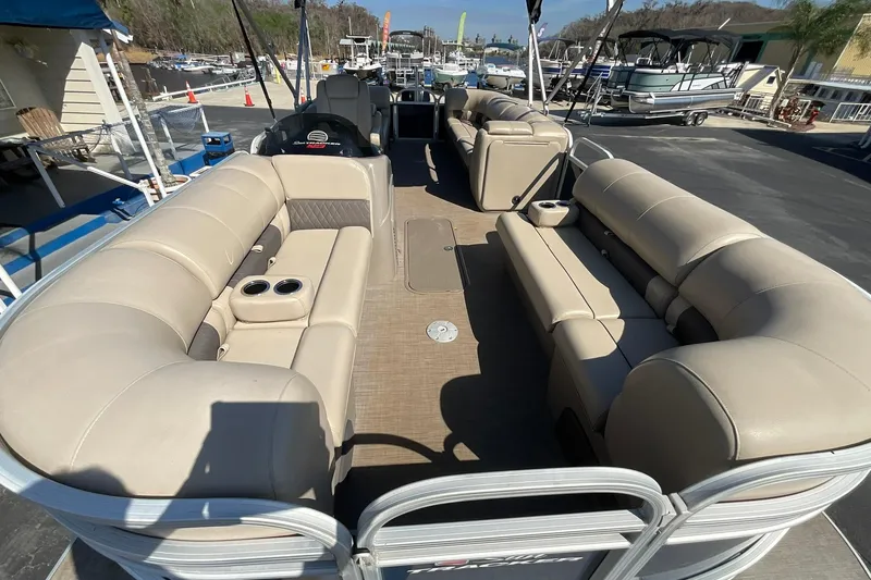 Slide: The Image of 2020 Sun Tracker Party Barge 22 XP3 with beige seating, docked at marina. - 11
