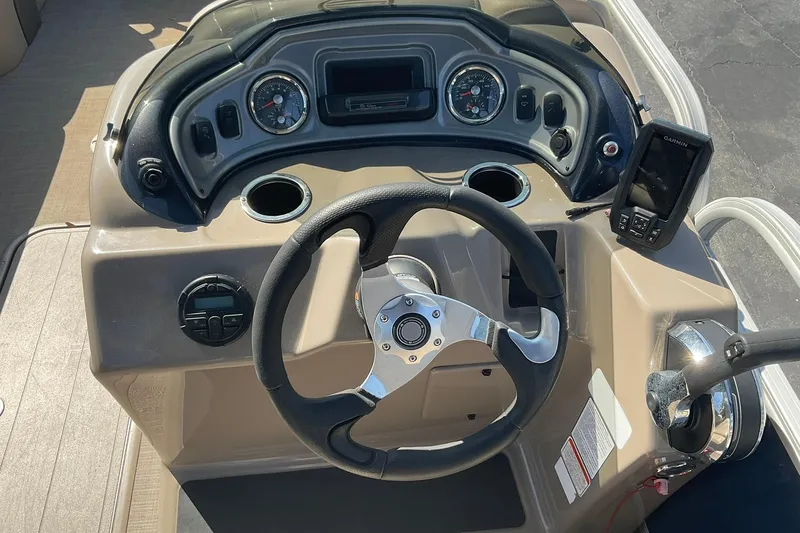 Slide: The Image of 2020 Sun Tracker Party Barge 22 XP3 dashboard with steering wheel and controls. - 16
