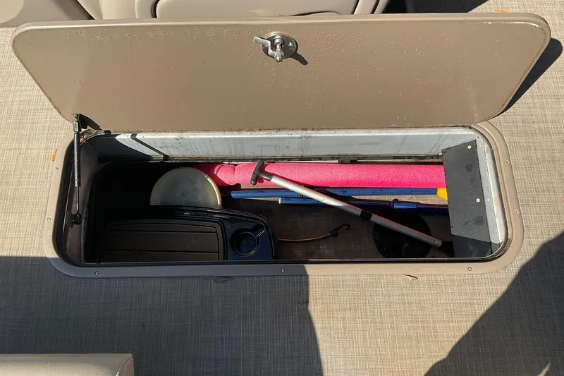 Slide: The Image of Storage compartment on a 2020 Sun Tracker Party Barge 22 XP3 with boating accessories. - 17