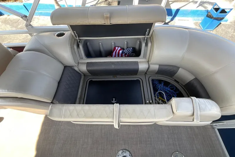 Slide: The Image of 2020 Sun Tracker Party Barge 22 XP3 seating with storage compartments open, showing ropes and flag. - 21