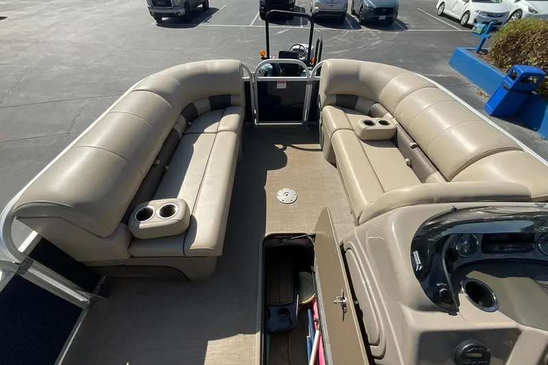 Slide: The Image of 2020 Sun Tracker Party Barge 22 XP3 interior with beige seating and cup holders. - 22
