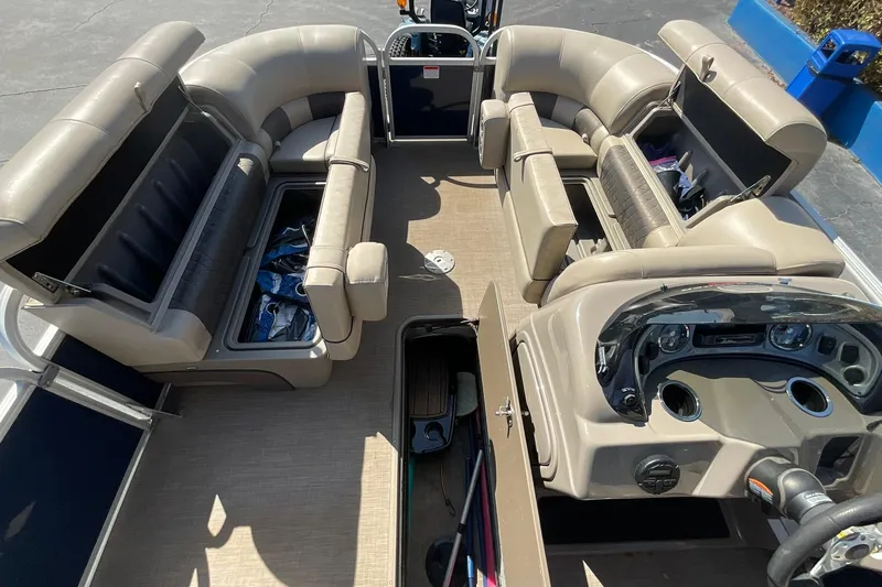 Slide: The Image of 2020 Sun Tracker Party Barge 22 XP3 interior with beige seating and storage compartments. - 23