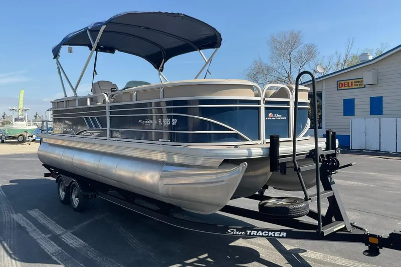 Slide: The Image of 2020 Sun Tracker Party Barge 22 XP3 pontoon boat on trailer, parked outdoors. - 6