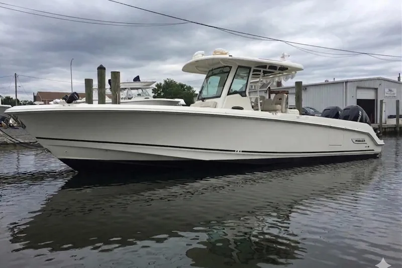 The Image of 2016 Boston Whaler 330 Outrage boat docked in a marina. - 0