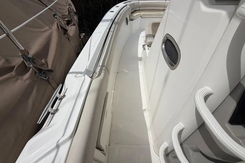 Slide: The Image of 2016 Boston Whaler 330 Outrage boat interior with seating and storage compartments. - 10