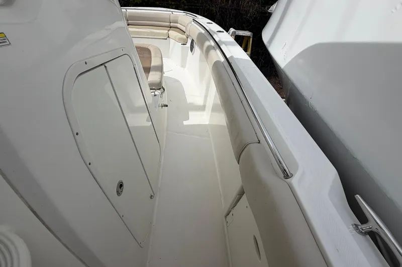Slide: The Image of 2016 Boston Whaler 330 Outrage boat interior with seating and storage compartments. - 11